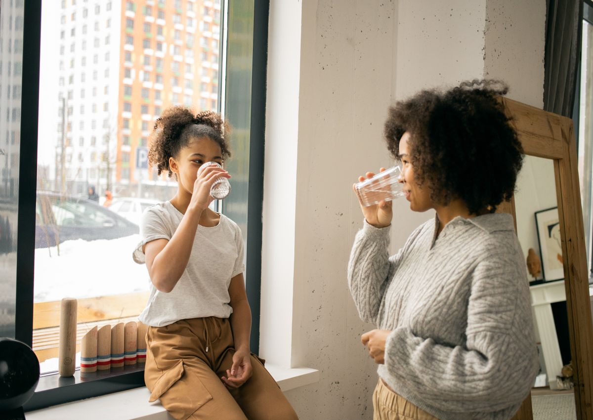 A mother and daughter drinking glasses of clean, great-tasting water — healthy hydration for the whole family