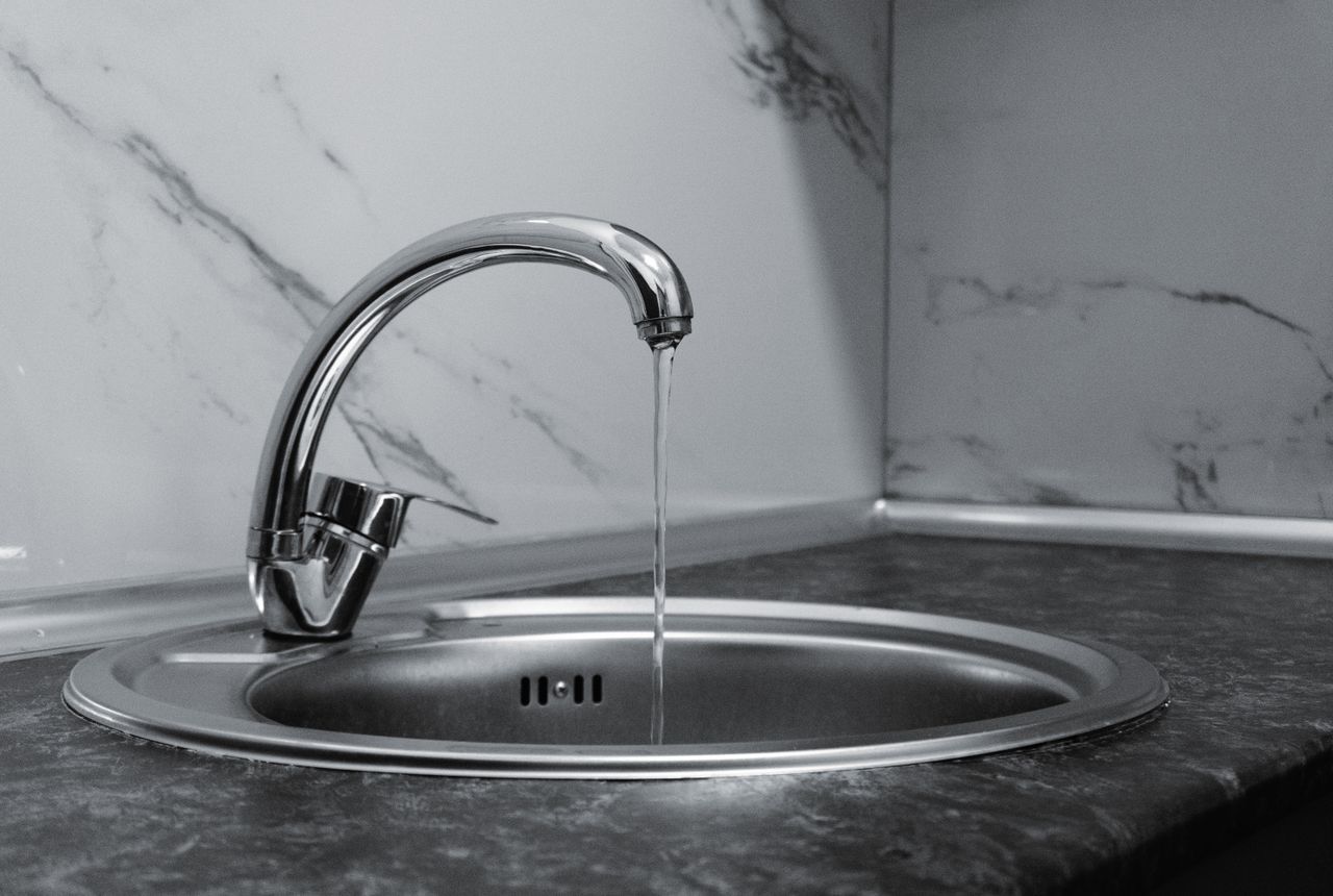 Clean, great-tasting filtered water flowing from a kitchen tap — whole-home filtration reaches every faucet