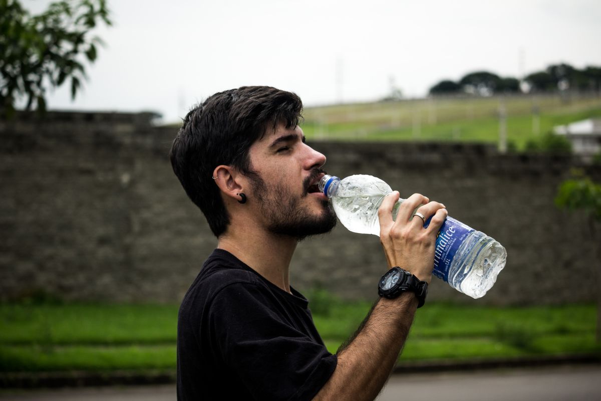 Man drinking clean, filtered water instead of relying on bottled water